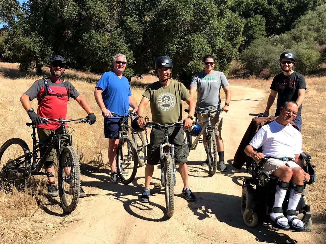 A group of men with mountain bikes on a trail
